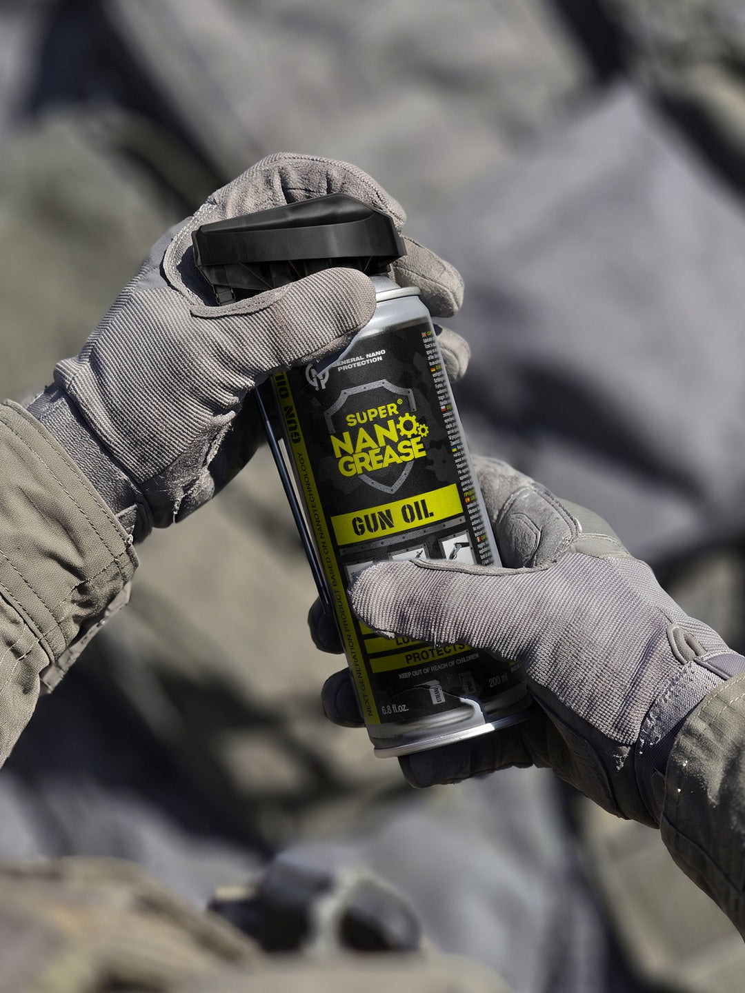 GNP Defend Gun Oil 200 ml can held in gloved hands