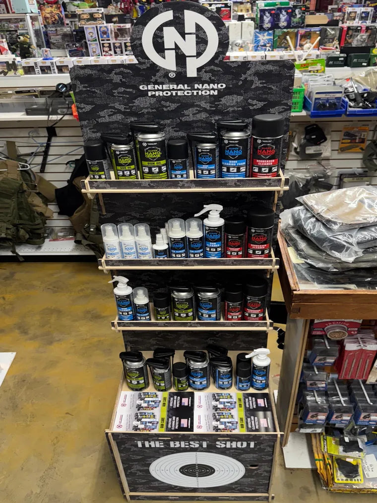 The GNP Defend floor display installed on a dealer's sales floor, stocked and fronted with take-one brochures on the lower shelf