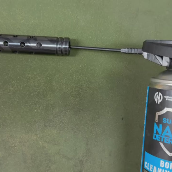 GNP Defend Bore Cleaning Foam sprayed through the straw into a ported muzzle device, foam coming out of every port