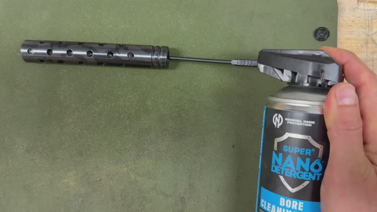 GNP Defend Bore Cleaning Foam sprayed through the straw into a ported muzzle device, foam coming out of every port